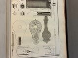 an open book with a drawing of a machine on it