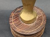a gold vase sitting on top of a wooden stand