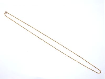 a close up of a gold necklace with a chain on a white background