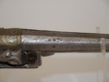 an old gun that is on display in a museum