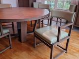 a wooden table with chairs around it in a room