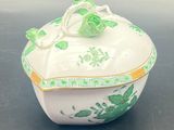 an image of a green and white bowl with a bow on top