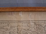 a picture of an old map on display in a wooden frame