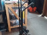 a dolly cart with wheels in a garage next to a stack of boxes