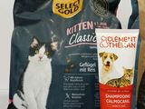 a cat sitting next to a bag of catnip and a bottle of catnip