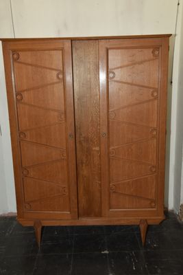 une photo d'une armoire en bois dans un coin d'une pièce