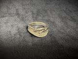 a gold ring sitting on top of a black surface