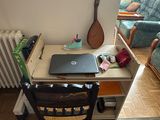 a desk with a laptop on it in a living room