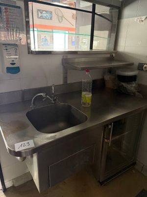 a kitchen with a sink and a refrigerator in it