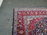 rug laying on the ground in the middle of a parking lot