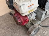 an image of a small engine with a hose attached to it