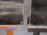 two pieces of art that are sitting on a table