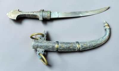 pair of old and rusty knifes on a white surface