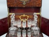 a wooden box with a set of glassware in it