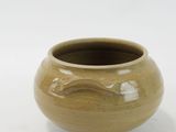 a small vase that is sitting on a white surface