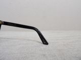 a pair of black glasses sitting on a white surface