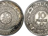 a silver coin with an image of a man on it