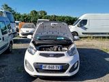 a small car with a broken hood sitting in a parking lot