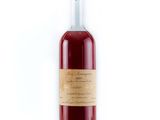 bottle of red wine with a label on it on a white background