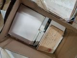 a box full of books and papers on the floor
