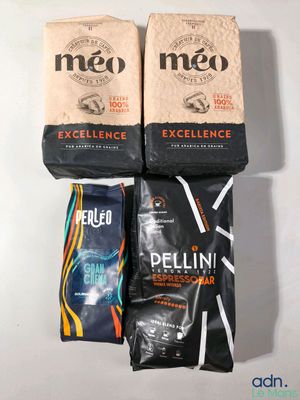 three bags of coffee sitting next to each other on a table