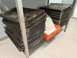 many stacks of papers stacked on a shelf in a room