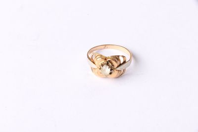 a close up of a gold ring on a white surface