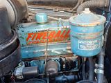 a close up of an old blue engine with a hose
