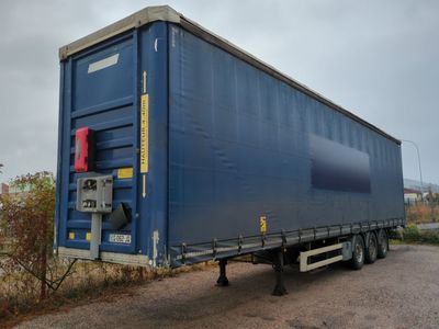 a large blue container truck parked on the side of the road