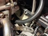 a close up of a car engine with a hose attached
