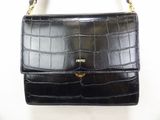 an image of a black purse on a white background