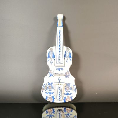 a white and blue guitar shaped object on a table