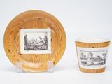 two cups and a plate with a picture on them