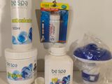 bottles of soap, toothbrushes, toothpaste, and toothpaste sitting on a counter
