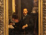 painting of a man in a suit sitting at a desk with a book