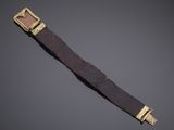 a close up of a brown belt with a gold buckle