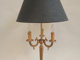 a lamp that is on a table with a black shade