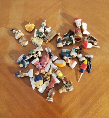 a pile of small figurines sitting on a wooden table
