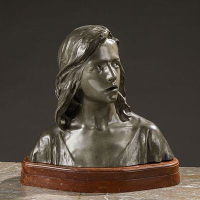 a bronze busturine of a woman smoking a cigarette