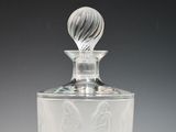 clear glass perfume bottle with a marbled top on a white surface