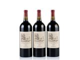 three bottles of red wine sitting next to each other on a white surface