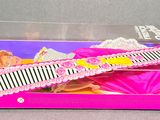 barbie doll hair comb and comb in a pink box on a gray surface