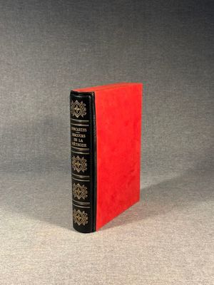a red book sitting on top of a gray surface
