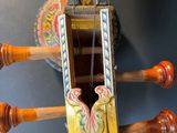 a small wooden musical instrument on display on a table