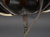 a close up of a helmet with a leather strap on it