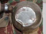 a metal pot sitting on top of a table next to a pair of scissors