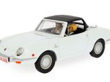 a white toy car with a dog in the back seat