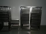 several trays of food are stacked on top of each other in a room