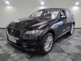 the black jaguar suv is parked on a checkered floor