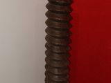 a tall wooden vase sitting in a corner of a room